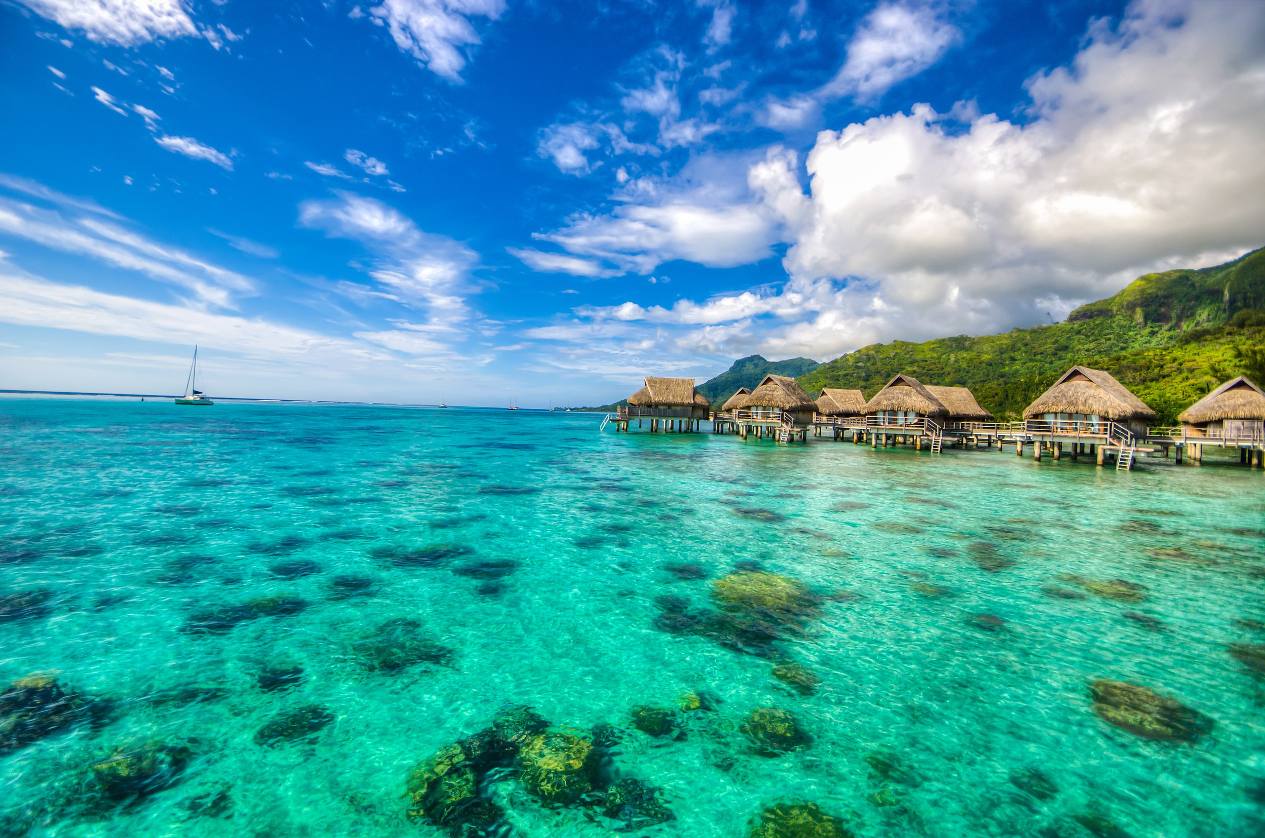 Bungalos built on stilts on a cove of turquoise water