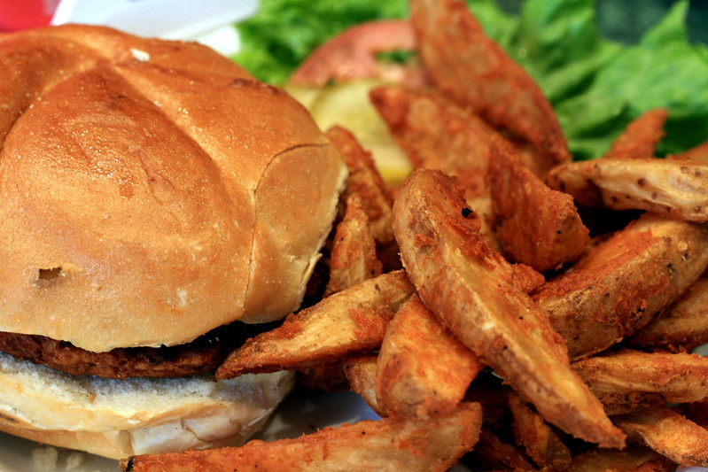 Burger and fried potato wedges