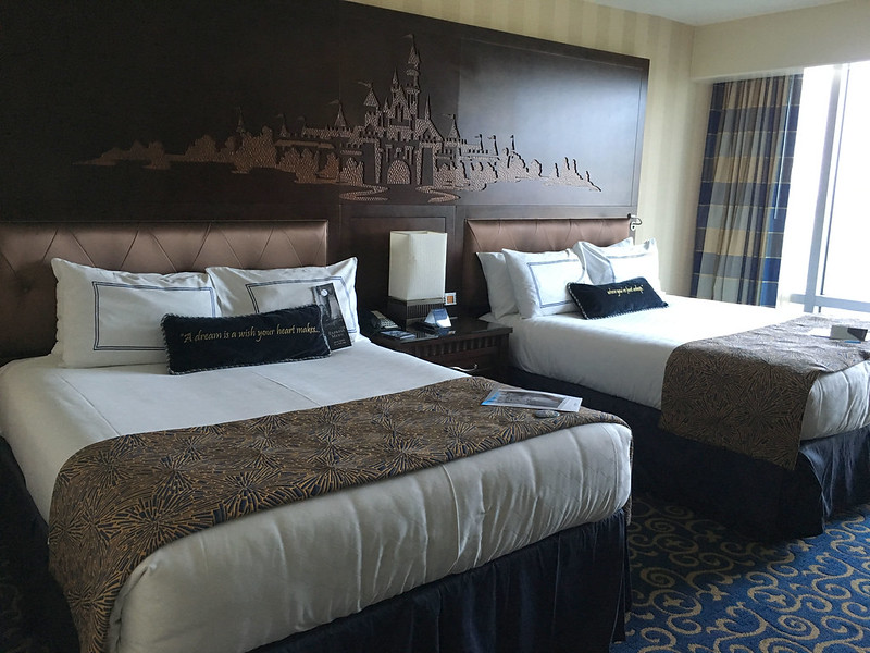 Two queen beds inside a hotel room